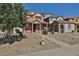Exterior view of a two-story home with landscaped yard, red front door, and a fire hydrant on the curb at 6843 S 9Th Ave, Phoenix, AZ 85041