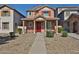 Charming two-story home with a welcoming front porch and gravel landscaping at 6843 S 9Th Ave, Phoenix, AZ 85041