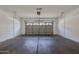 Open garage with sealed concrete flooring and a garage door at 6843 S 9Th Ave, Phoenix, AZ 85041