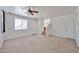 Bright living room with carpet, a ceiling fan, and a staircase leading to the upper level at 6843 S 9Th Ave, Phoenix, AZ 85041