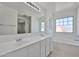 Well-lit main bathroom with double sinks, a large mirror, and a soaking tub at 6843 S 9Th Ave, Phoenix, AZ 85041