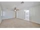 Bright main bedroom with neutral carpet, ceiling fan, and access to the en-suite bathroom at 6843 S 9Th Ave, Phoenix, AZ 85041