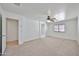 Expansive main bedroom with a ceiling fan, neutral carpet, and access to the en-suite bathroom at 6843 S 9Th Ave, Phoenix, AZ 85041
