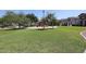 Community park with green grass, picnic tables, a playground and various homes surrounding the perimeter at 6843 S 9Th Ave, Phoenix, AZ 85041