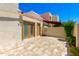 A spacious back patio with tile flooring and exterior doors leading to the home at 7802 E Rovey Ave, Scottsdale, AZ 85250
