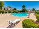 Enjoy a refreshing community pool with lounge chairs, mature landscaping, and seating areas at 7802 E Rovey Ave, Scottsdale, AZ 85250
