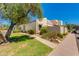 Charming single-story home with desert landscaping, mature shade tree, and covered parking at 7802 E Rovey Ave, Scottsdale, AZ 85250