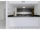 Kitchen passthrough into living area; features granite countertops and stainless steel appliances at 7802 E Rovey Ave, Scottsdale, AZ 85250