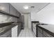 Well lit kitchen with modern appliances and stainless steel backsplash and dark countertops at 7802 E Rovey Ave, Scottsdale, AZ 85250