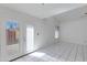 Bright living area with tiled floor and French doors that lead to the backyard patio at 7802 E Rovey Ave, Scottsdale, AZ 85250