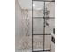 Modern shower with decorative tile and black framed glass partition at 7806 N Via Del Sol --, Scottsdale, AZ 85258