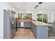Bright kitchen featuring an island, stainless steel appliances, views to the backyard, and tiled floors at 7806 N Via Del Sol --, Scottsdale, AZ 85258