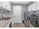 Well-lit laundry room with modern washer and dryer, ample storage, and tile flooring at 7806 N Via Del Sol --, Scottsdale, AZ 85258