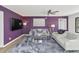 Contemporary living room featuring gray sofas, wood-look floors, a textured rug, and a purple accent wall at 7806 N Via Del Sol --, Scottsdale, AZ 85258