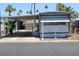 Cozy mobile home featuring covered parking, a small storage shed, and a neatly maintained yard at 7807 E Main St # D-26, Mesa, AZ 85207
