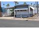 Manufactured home exterior with a covered carport and window awnings, located in a community at 7807 E Main St # D-26, Mesa, AZ 85207