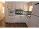 Well-lit kitchen featuring modern appliances and white cabinetry, maximizing space and functionality at 7807 E Main St # D-26, Mesa, AZ 85207