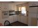 Updated kitchen featuring modern appliances, abundant cabinetry, and stylish backsplash at 7807 E Main St # D-26, Mesa, AZ 85207