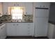 Efficient kitchen with sleek countertops, modern appliances, and ample cabinet space at 7807 E Main St # D-26, Mesa, AZ 85207
