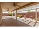 Spacious covered back patio boasts ceiling fans and views of the landscaped backyard at 7839 E Milagro Ave, Mesa, AZ 85209