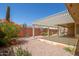 Expansive backyard featuring covered patio, desert landscaping, and mature vegetation at 7839 E Milagro Ave, Mesa, AZ 85209