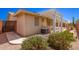 Backyard features a covered patio, mature plants, gravel landscape and an air conditioning unit at 7839 E Milagro Ave, Mesa, AZ 85209