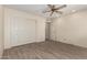 Bedroom with wood-look floors features a large closet with bi-fold doors and neutral paint at 7839 E Milagro Ave, Mesa, AZ 85209