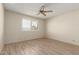 Bright bedroom features wood-look floors, ceiling fan and a sunlit window with shutter-style blinds at 7839 E Milagro Ave, Mesa, AZ 85209