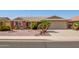 Charming single-story home with a well-manicured front yard and attached two-car garage at 7839 E Milagro Ave, Mesa, AZ 85209