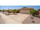 Well-maintained brick home with desert landscaping and a spacious driveway leading to a two-car garage at 7839 E Milagro Ave, Mesa, AZ 85209