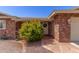 Inviting front porch of a brick home, featuring a decorative wreath on the front door at 7839 E Milagro Ave, Mesa, AZ 85209