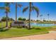 Community Golf Course entrance featuring lush landscaping, palm trees, and a water feature at 7839 E Milagro Ave, Mesa, AZ 85209