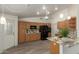 Open concept kitchen with wood cabinets and black appliances at 7839 E Milagro Ave, Mesa, AZ 85209