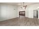 Bright living room with neutral walls, ceiling fan, and wood-look tile flooring at 7839 E Milagro Ave, Mesa, AZ 85209