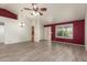 Open-concept living room featuring tile floors, ceiling fan, and natural light at 7839 E Milagro Ave, Mesa, AZ 85209