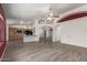 Open-concept living space with tile floors seamlessly flowing into the kitchen area at 7839 E Milagro Ave, Mesa, AZ 85209