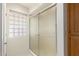 Bathroom featuring a shower with sliding glass doors and a glass block window at 7839 E Milagro Ave, Mesa, AZ 85209