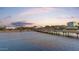 Aerial view of the bridge and the waterway, with the city skyline visible against a colorful sunset backdrop at 945 E Playa Del Norte Dr # 4019, Tempe, AZ 85288