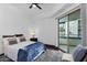 Cozy bedroom with balcony access, contemporary design, and a ceiling fan at 945 E Playa Del Norte Dr # 4019, Tempe, AZ 85288