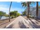 Well maintained walking path with palm trees and lake views on either side of sidewalk at 945 E Playa Del Norte Dr # 4019, Tempe, AZ 85288
