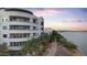 Exterior view of modern building along the waterway, adjacent to the walking path and lush greenery at 945 E Playa Del Norte Dr # 4019, Tempe, AZ 85288