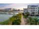 View showcasing the building's proximity to a waterway and a paved walking path, bordered by lush greenery at 945 E Playa Del Norte Dr # 4019, Tempe, AZ 85288