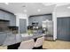 Stylish kitchen with stainless steel appliances, gray cabinets, and a large center island with seating at 945 E Playa Del Norte Dr # 4019, Tempe, AZ 85288