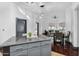 Open concept kitchen with a gray island and stainless steel appliances, connecting to the living and dining areas at 945 E Playa Del Norte Dr # 4019, Tempe, AZ 85288