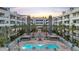 Community pool showcasing barbecue areas and lounge seating, surrounded by palm trees within the building complex at 945 E Playa Del Norte Dr # 4019, Tempe, AZ 85288
