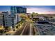 An attractive street view during sunset with palm trees and stunning commercial buildings at 945 E Playa Del Norte Dr # 4019, Tempe, AZ 85288