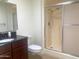 Bathroom featuring vanity, toilet, and glass door shower at 9708 W Redwood Dr, Sun City, AZ 85351