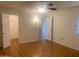 Bedroom with a ceiling fan, laminate flooring, and multiple doors at 9708 W Redwood Dr, Sun City, AZ 85351