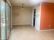 Dining room has tan tiling throughout, with orange accent wall, and sliding door to outside at 9708 W Redwood Dr, Sun City, AZ 85351