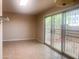 Living space with tan tiling and sliding door to outside with decorative metal bars at 9708 W Redwood Dr, Sun City, AZ 85351